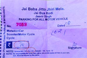 A parking slip shows more money being charged from visitors than the actual rates at Jhiri Mela in Jammu