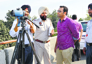The police show a speed reading to a car owner in Ludhiana. 