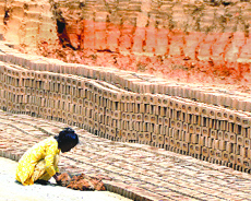 A child works at a brick-kiln.