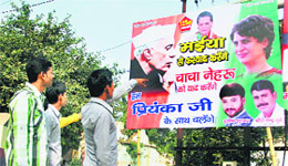 A Congress activist looks at a hoarding demanding the leadership role for Priyanka Gandhi on the eve of Jawaharlal Nehrus 125th birth anniversary in Allahabad on Thursday
