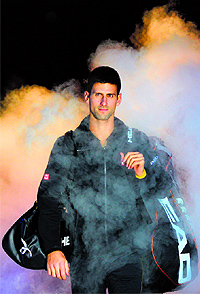 Novak Djokovic walks through dry ice before his match against Stanislas Wawrinka