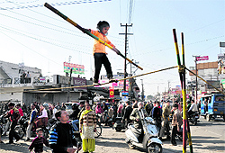 a child does a tightrope walk in Dehradun on Thursday