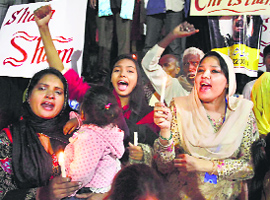 Pakistani Christians shout anti-government slogans during a rally to condemn killing of a Christian couple, in Lahore, on Wednesday.