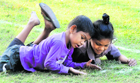 Unaware of the Children's Day and their rights, slum children play at a park;.