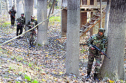 Armymen near the house where LeT militants were hiding at Chengam village in Kulgam district, on Friday