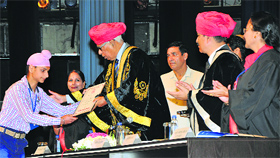 Governor NN Vohra presents the PhD degree of late Gurcharan Singh to his son Navneet Singh during the special convocation of the University of Jammu on Friday.