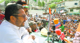 Congress candidate from Kargil Haji Asgar Karbalai addresses people at a rally.