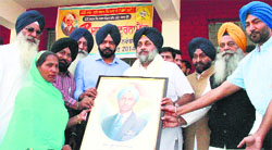 Deputy Chief Minister Sukhbir Badal being honoured by members of Shaheed Kartar Singh Sarabha Sports Club at Sarabha village in Ludhiana district on Friday. A Tribune photograph