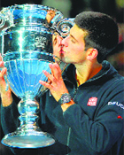 Djokovic kisses the ATP World No 1 Trophy after it was presented to him following his win over Tomas Berdych on Friday.