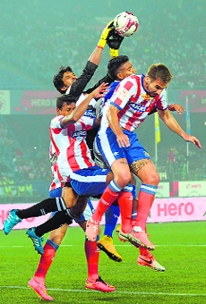 Kolkata goalkeeper Subhasish Roy Chowdhury (C) makes a save during the ISL match against Chennaiyin FC.