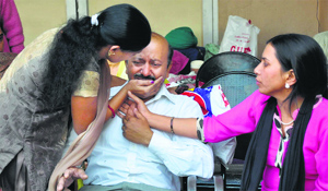 Brij Lal, father of Andrey, who died in the road accident, being consoled by relatives. 