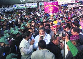 Chief Minister Harish Rawat interacts with people during a rally on water conservation through rain water harvesting in Mussoorie on Saturday