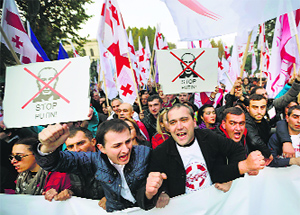 People shout slogans during a rally in Tbilisi on Saturday.