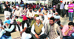 Shopkeepers hold demonstration on the Airport road in Amritsar