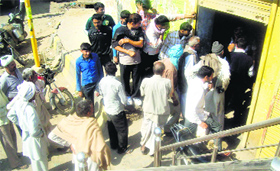 Farmers gather outside a HAFEDs sales counter in Jhajjar on Saturday.