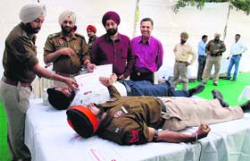 Policemen donate blood during the World Remembrance Day for Road Traffic Victims in Jalandhar on Sunday