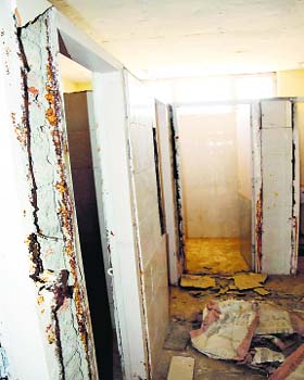 Damaged door frames and bathroom walls of the girls hostel