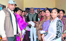 Haridwar city legislator Madan Kaushik gives away certificates to women, who participated in a one-month training programme in Haridwar on Sunday.