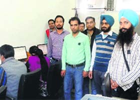 SSA-RMSA and the non- teaching staff of the District Education Office hold a protest wearing black badges in Bathinda on Monday