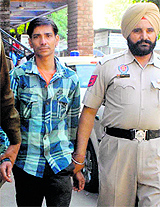 The accused, Rajesh Kumar, comes out of the District Courts in Mohali on Monday