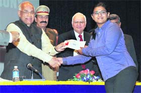 Honouring the meritorious: Governor Kaptan Singh Solanki awards a scholarship to a student at ITM University in Gurgaon on Monday