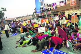 Rampals followers kneel down as the police ask them to vacate Satlok Ashram at Barwala in Hisar district on Monday