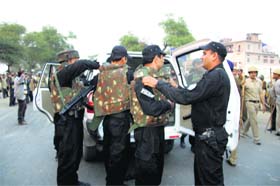 Police commandoes wear bullet-proof jackets to get ready for action