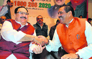 Union Health Minister J P Nadda shakes hand with Vijay Sampla during the launch of the BJP membership drive in Jalandhar on Monday