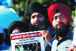 People hold a protest over the 1984 anti-Sikh riots near Allphones Arena where Prime Minister Narendra Modi was addressing a function, in Sydney on Monday.