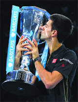 Novak Djokovic kisses the trophy after winning the ATP World Tour Finals title for the third consecutive time in London on Sunday.
