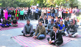 Striking Secretariat employees hold a meeting before calling off their strike in Dehradun on Monday.