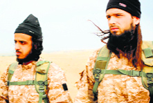 An image grab taken from a propaganda video released by al-Furqan Media allegedly shows members of the Islamic State, with among them a jihadist believed to be French citizen Maxime Hauchard (R), also known as Abu Abdallah al-Faransi, before taking part in the beheadings of at least 18 men described as Syrian military personnel.