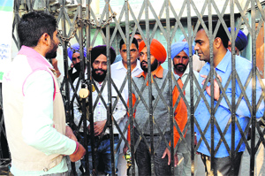 Farmers seeking loans lock the gate of the Cooperative Bank to protest against the management in Bathinda on Tuesday.