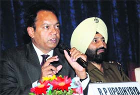 Inspector General of Police RP Upadhyay interacts with residents during a police-public interaction at the Law Bhawan in Sector 37, Chandigarh, on Tuesday