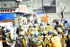 Police chase away Sant Rampals followers in Barwala on Tuesday. 