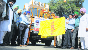 Verka Milk Plant chairman Ajmer Singh Bhagpur flags off a van carrying milk products to village cooperatives from the plant in Ludhiana