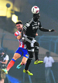 Atletico De Kolkata and North East United FC players fight for the ball during their ISL match in Kolkata on Tuesday