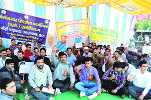 Unemployed diploma pharmacists hold a demonstration to seek government jobs in Dehradun on Tuesday