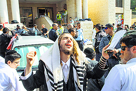 A jewish man prays at the scene of an attack in Jerusalem. 