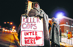 A demonstrator during a protest over the shooting death of Michael Brown in front of the Ferguson Police Department. 