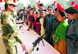 Cadets look at weapons during an exhibition organised by the BSF on NCC Day in Amritsar on Wednesday