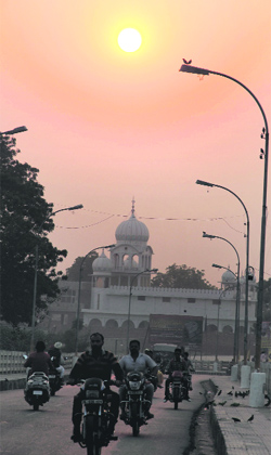 A view of the sunset in Bathinda on Wednesday evening as commuters make their way home after work.
