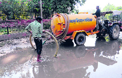 Employees of the MCB clear the sewage water that had accumulated on road in the Civil Lines area in Bathinda on Tuesday.