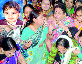 Relatives mourn the death of Utkarsh (inset) at Gandhi Nagar in East Delhi on Wednesday.