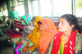 After leaving Satlok Ashram, devotees wait at the railway station in Jind on Wednesday