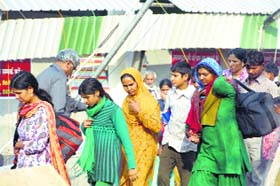 Devotees come out of the ashram on Wednesday