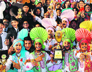 Students of Police DAV School in a jubilant mood after winning the overall trophy at the inter-school youth festival in Jalandhar on Wednesday.