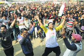 Supporters dance during the rally of Democratic Party Nationalist chief and Agriculture Minister Ghulam Hassan Mir after he filed his nomination papers in Baramulla district on Wednesday.