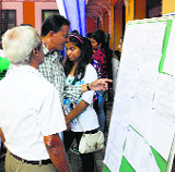 People go through the schedule of the film fest in Panjim on Wednesday.