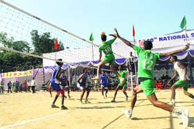 A player of the Bihar team smashes the ball in a match against Lakshadweep in the Under-17 National School Volleyball Tournament in Dehradun on Wednesday